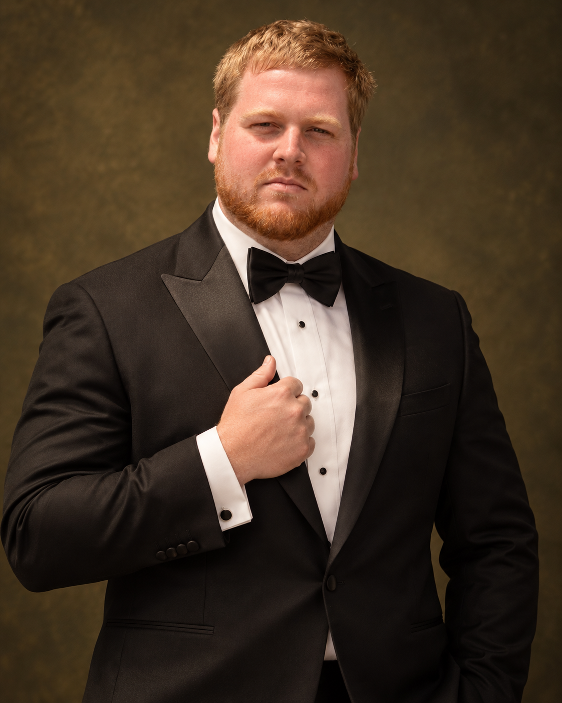 Vito wearing a black tuxedo with an extremely serious expression